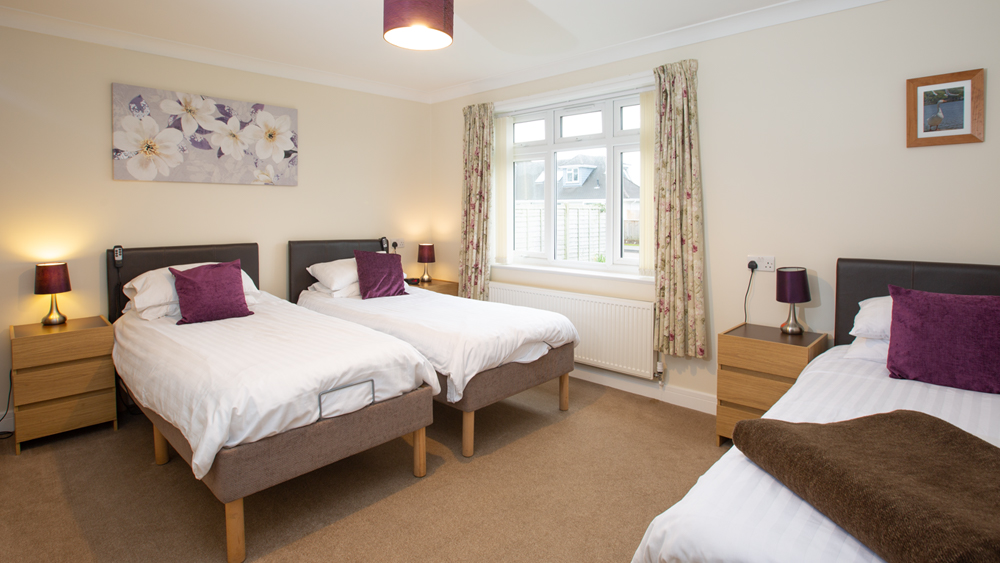 Large 2nd bedroom with three single beds ideal for families