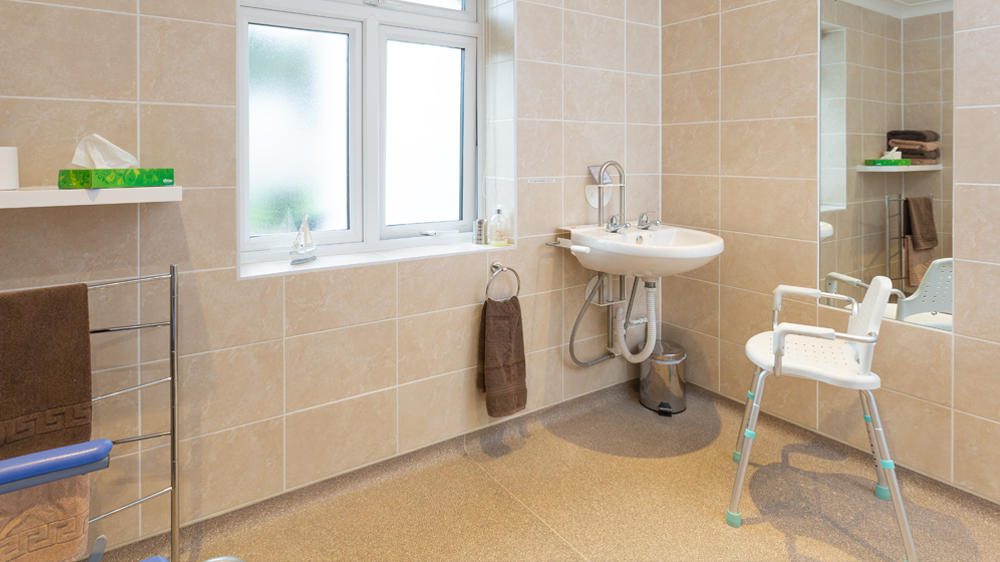 height adjustable sink in the wet room and optional perching stool