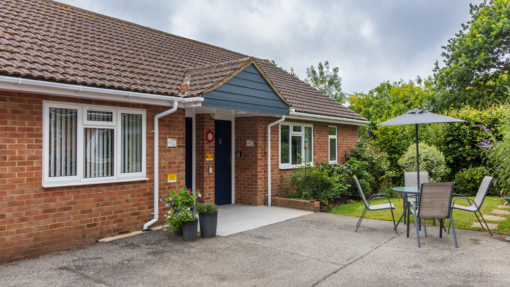 Shared entrace with garden bench and level to the car park.