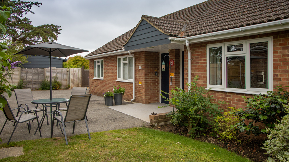 Shared garden with seating available by the door.