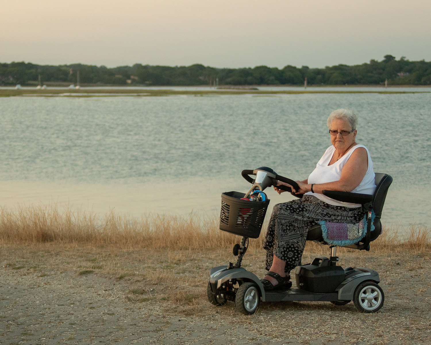 One person in a mobility scooter by the coast