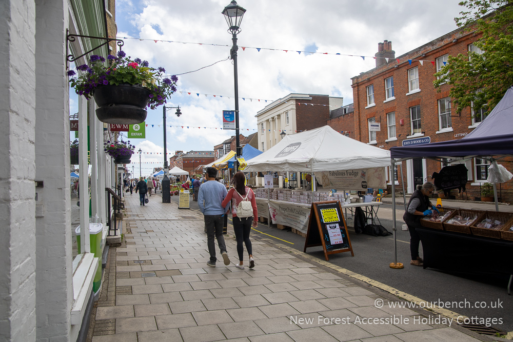 Market stalls and shoppers on Lymington’s High Street on a sunny market day