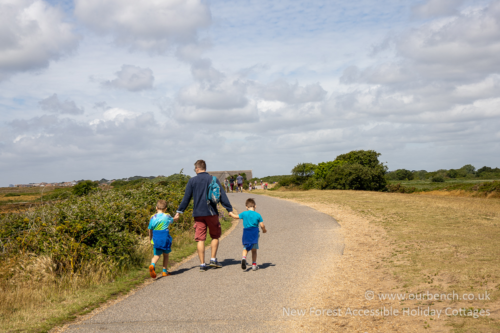 Smooth path leading towards the beach huts at Hengistbury Head